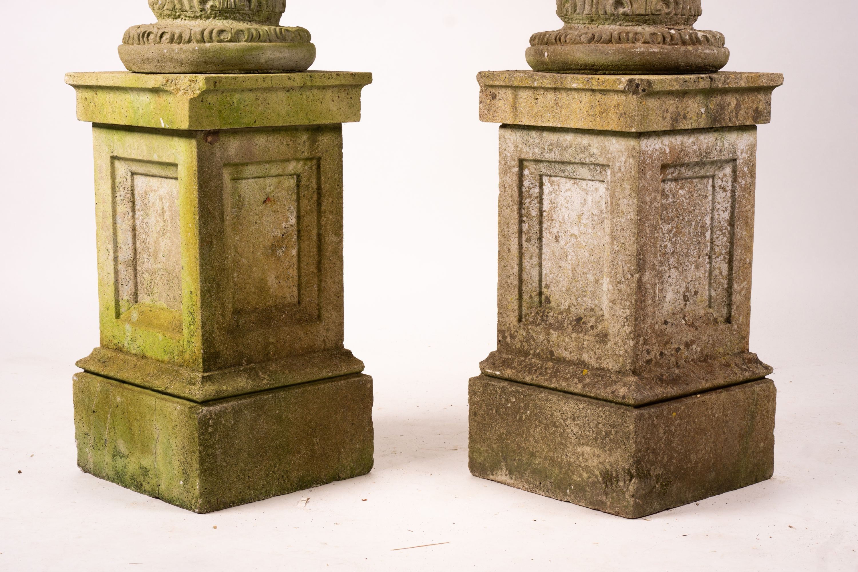 A pair of reconstituted stone circular garden planters on pedestal bases, diameter 45cm, height 110cm